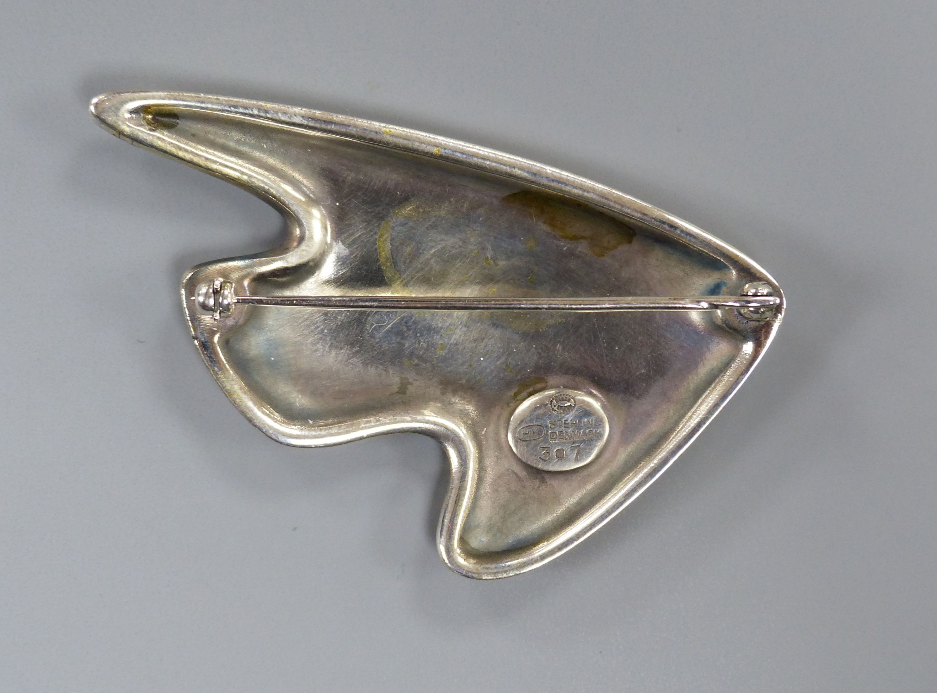 A George Jensen sterling and two colour purple enamel stylised fish brooch, designed by Henning Koppel, no. 307, 61mm.